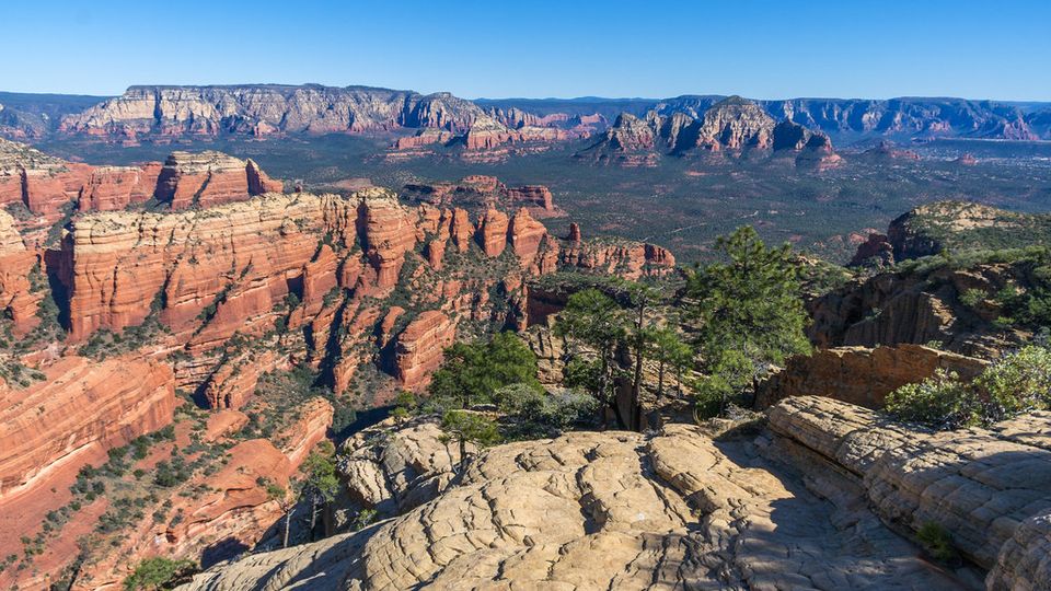 Red sandstone canyon and mesas under a clear blue sky