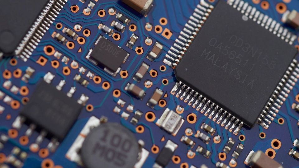 Close-up of a microchip on a blue circuit board