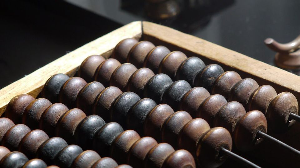 Wooden abacus with rows of dark beads